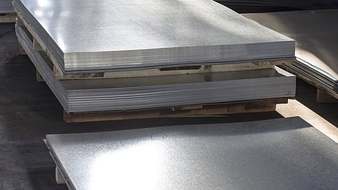 Stacked metal panels prepared for construction and insulation projects in a warehouse facility