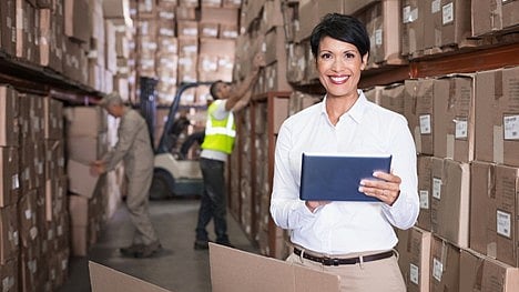 Warehouse manager in a distribution center overseeing inventory and shipping operations