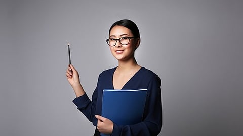 Woman holding notebook and pen representing nonverbal communication and doula support training