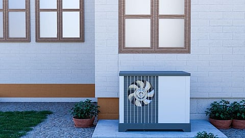 Outdoor heat pump unit beside home showing HVAC system for home maintenance