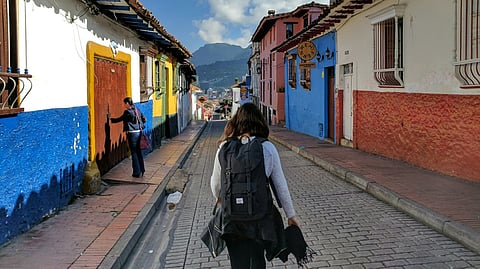 Infinity pool terrace with loungers overlooking ocean and lush tropical coastline
