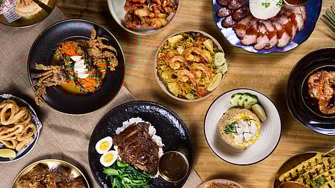 Top-down view of multiple Thai dishes on dining table