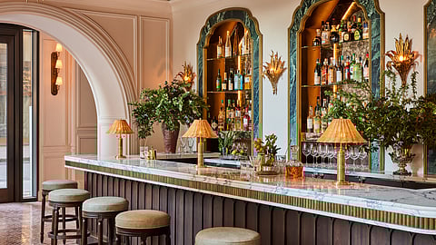 Elegant marble bar at La Marchande with warm lighting and classic NYC hotel design