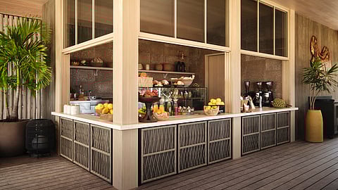 Open-air market with bakery counter and tropical fruit displays