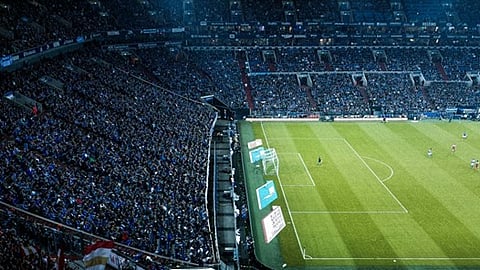 Crowded football stadium with fans watching match from above