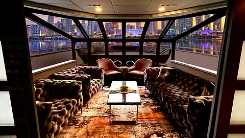 Luxury yacht interior lounge with city skyline views at sunset