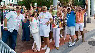 Group of guests smiling and posing at Las Olas Boulevard event in Fort Lauderdale