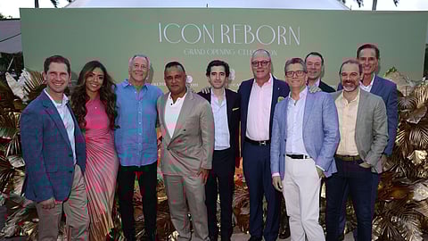 Group of well-dressed guests posing at luxury resort grand opening event in Miami