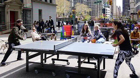 People playing ping pong on car-free streets in Flatiron NoMad during Earth Month in New York City