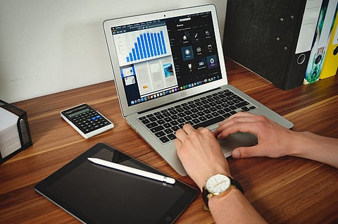A person working at a home office workstation
