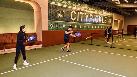 Players rally on indoor pickleball court at CityPickle Times Square in New York City