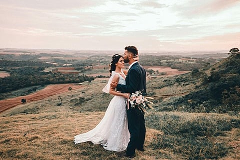 A couple during a wedding photography session on a hillside