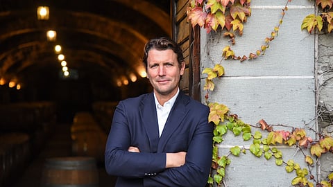 Salvatore Ferragamo Jr. standing in a vineyard cellar entrance at Il Borro estate