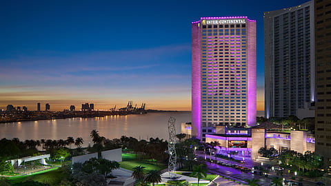 InterContinental Miami hotel illuminated at night overlooking Biscayne Bay and downtown skyline