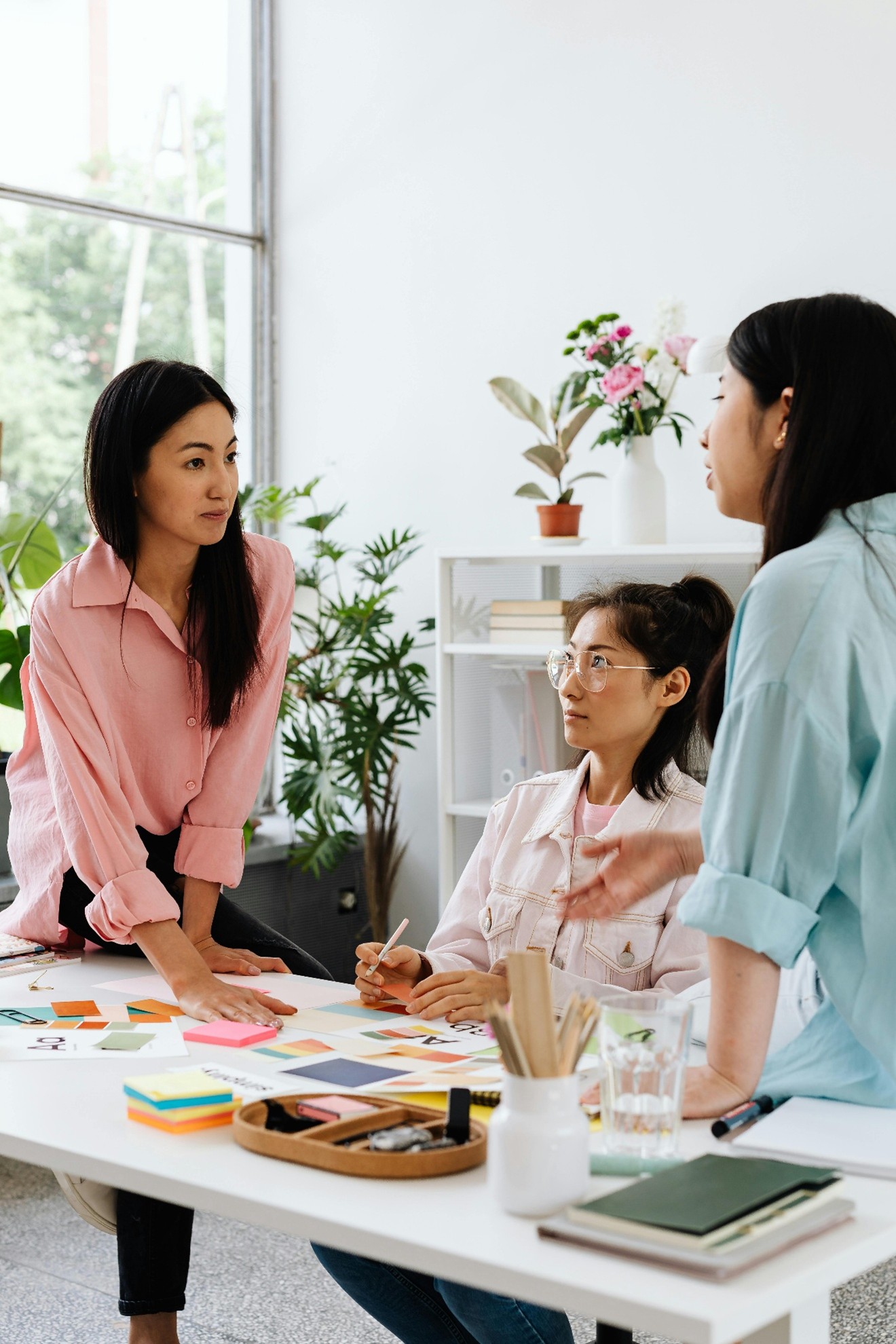 Three women collaborating in a modern office