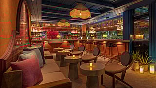 Serena Rooftop bar at Moxy South Beach with lounge seating, bar, and warm lighting