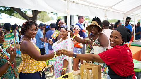 Guests enjoying mango tastings and drinks at Nevis Mango Festival outdoor event