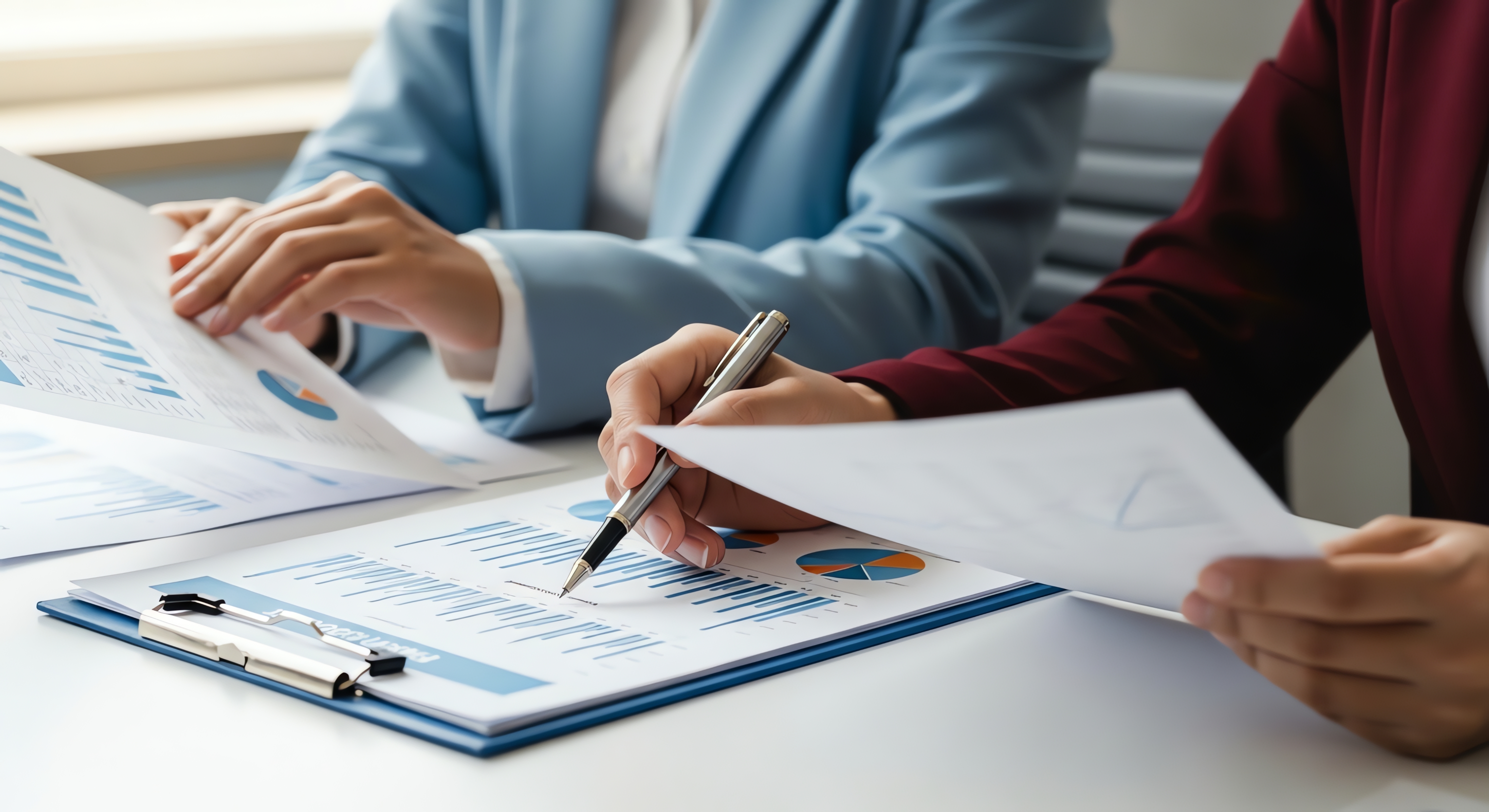 Professionals reviewing charts and reports during a business analysis meeting