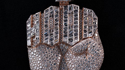 Full view of diamond fist pendant with HOOD lettering in baguette diamonds