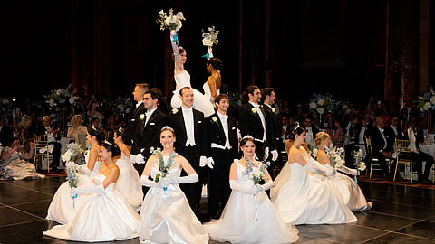 Debutantes in white ball gowns and their escorts on the Viennese Opera Ball dance floor