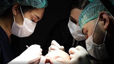 a team of medical professionals performing a surgical procedure