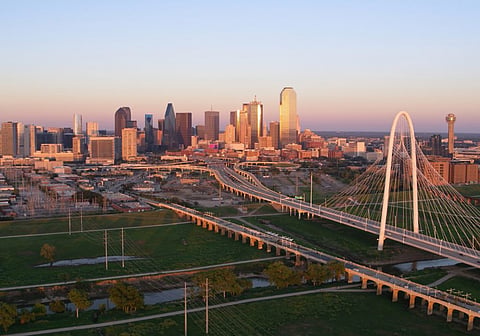 Dallas, Margaret Hunt Hill Bridge on the right and the downtown Dallas skyline at sunset
