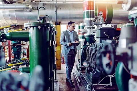 an engineer or plant manager performing a Gemba walk