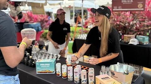 Festival guests visit the Gin & Juice by Dre and Snoop beverage activation booth