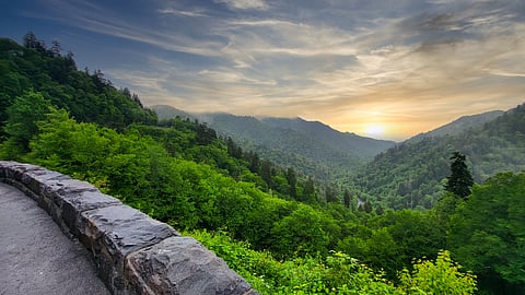 Misty mountain ridges glow beneath a sunset sky in Great Smoky Mountains National Park