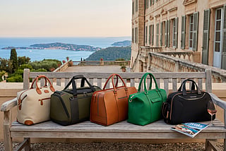 5 weekend bags sitting on a bench 