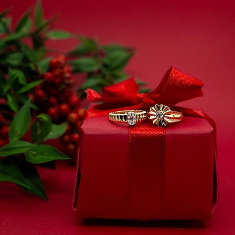 yellow gold statement rings featuring a textured band and a sunburst-inspired setting