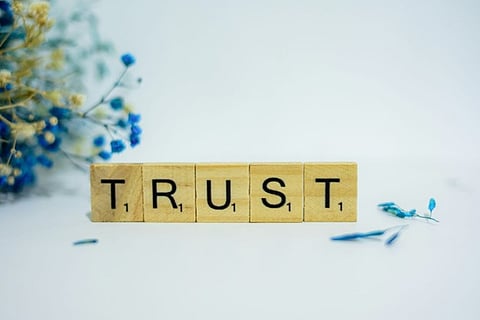 wooden letter blocks spelling out "TRUST"