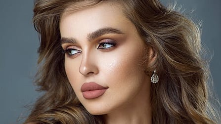 a close-up portrait of a woman with styled hair