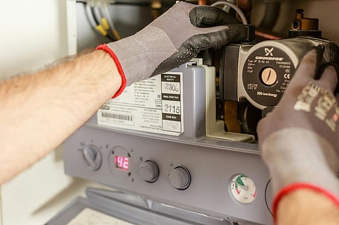 a professional repairing a boiler system