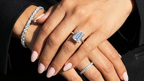 a Leonids jewelry set featuring a prominent emerald-cut diamond engagement ring