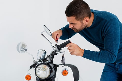 a man fixing the bike handle