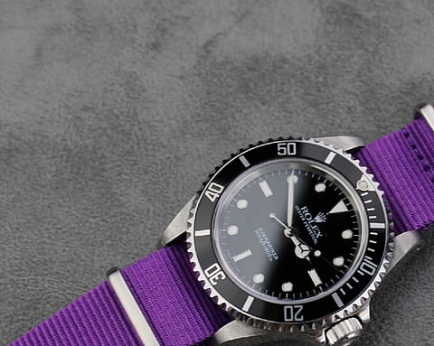 Rolex Submariner is paired with a vibrant purple nylon NATO strap