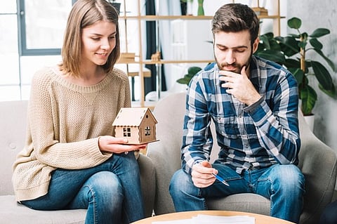 a couple engaged in a discussion about buying a home