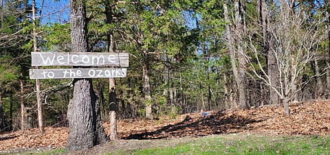 a handmade sign welcoming visitors to the Ozarks