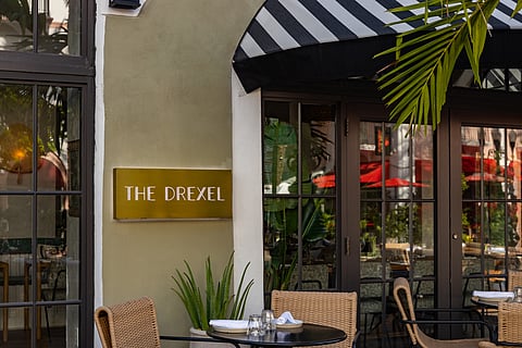 The Drexel front entrance with a striped awning