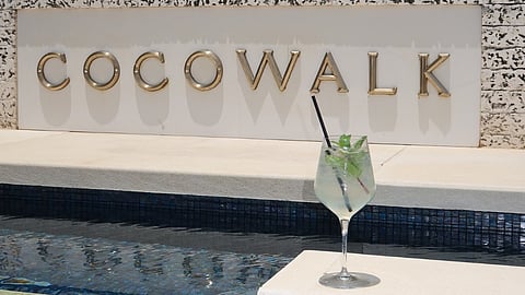 CocoWalk fountain display with a signature cocktail during the Summer Solstice Celebration