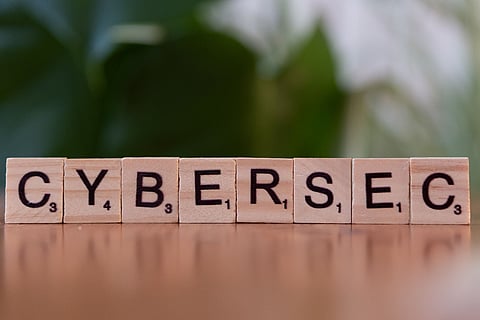 wooden Scrabble tiles spelling out the word "CYBERSEC"