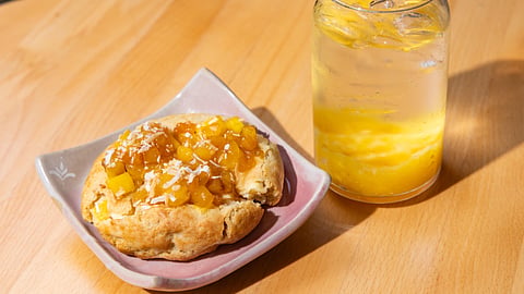 Mango cookie topped with fresh mango beside a Mango Agua Fresca beverage