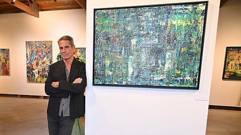 Artist Mark Seidenfeld poses with his artwork at the Bridgehampton Museum