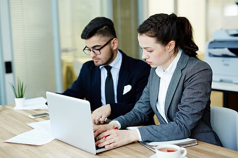 two individuals collaborating in a professional office