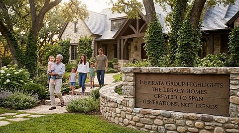 Multi-generational family walking up a stone path to a stone-and-timber house.