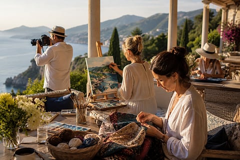 People painting, photographing, and crafting on a scenic coastal terrace