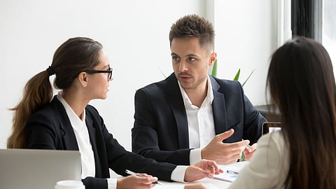 Professionals discuss software development strategy during a business meeting.
