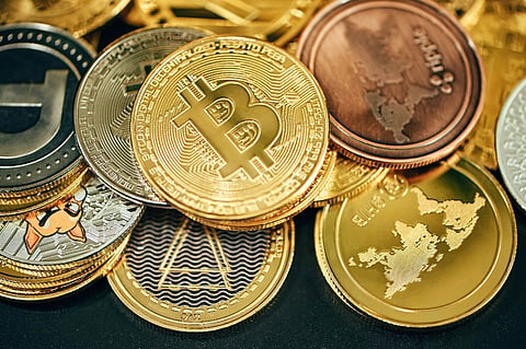 Close-up of Bitcoin and cryptocurrency coins arranged together with digital currency symbols.