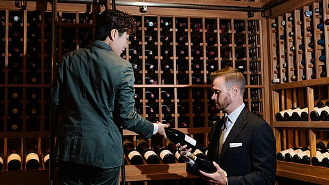 Wine professionals select bottles in Caruso's award-winning wine cellar